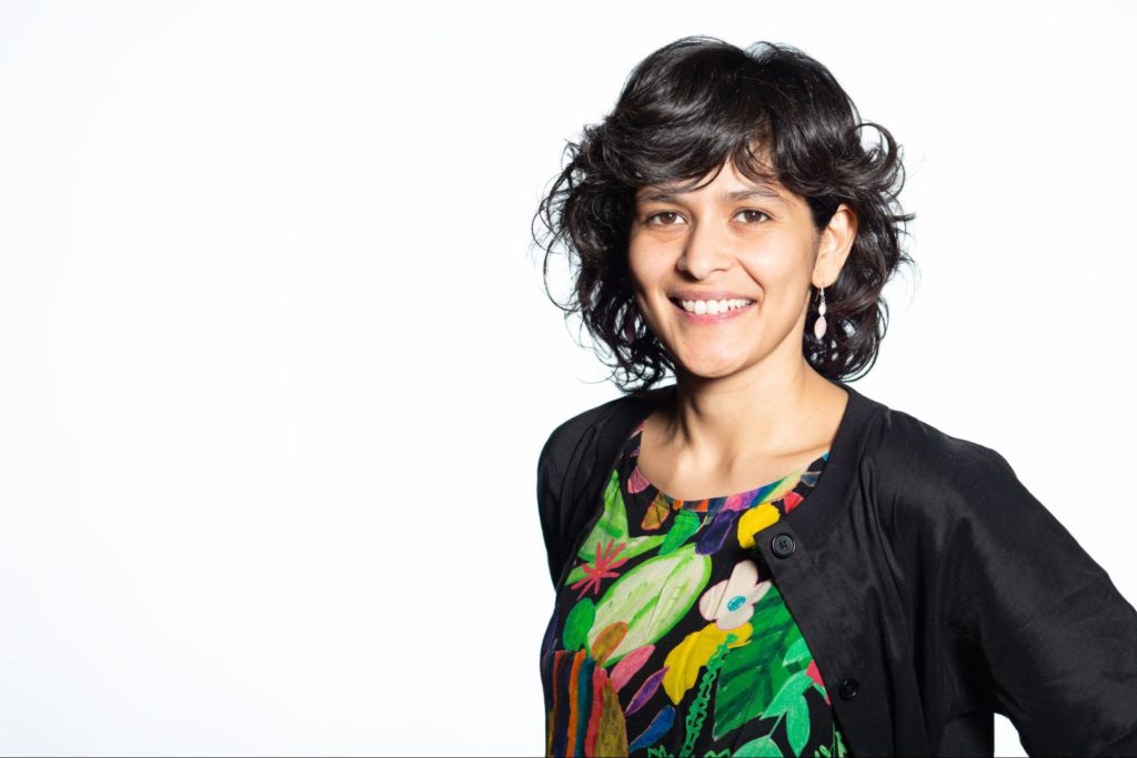 Portrait of young woman with short black hair and green floral shirt