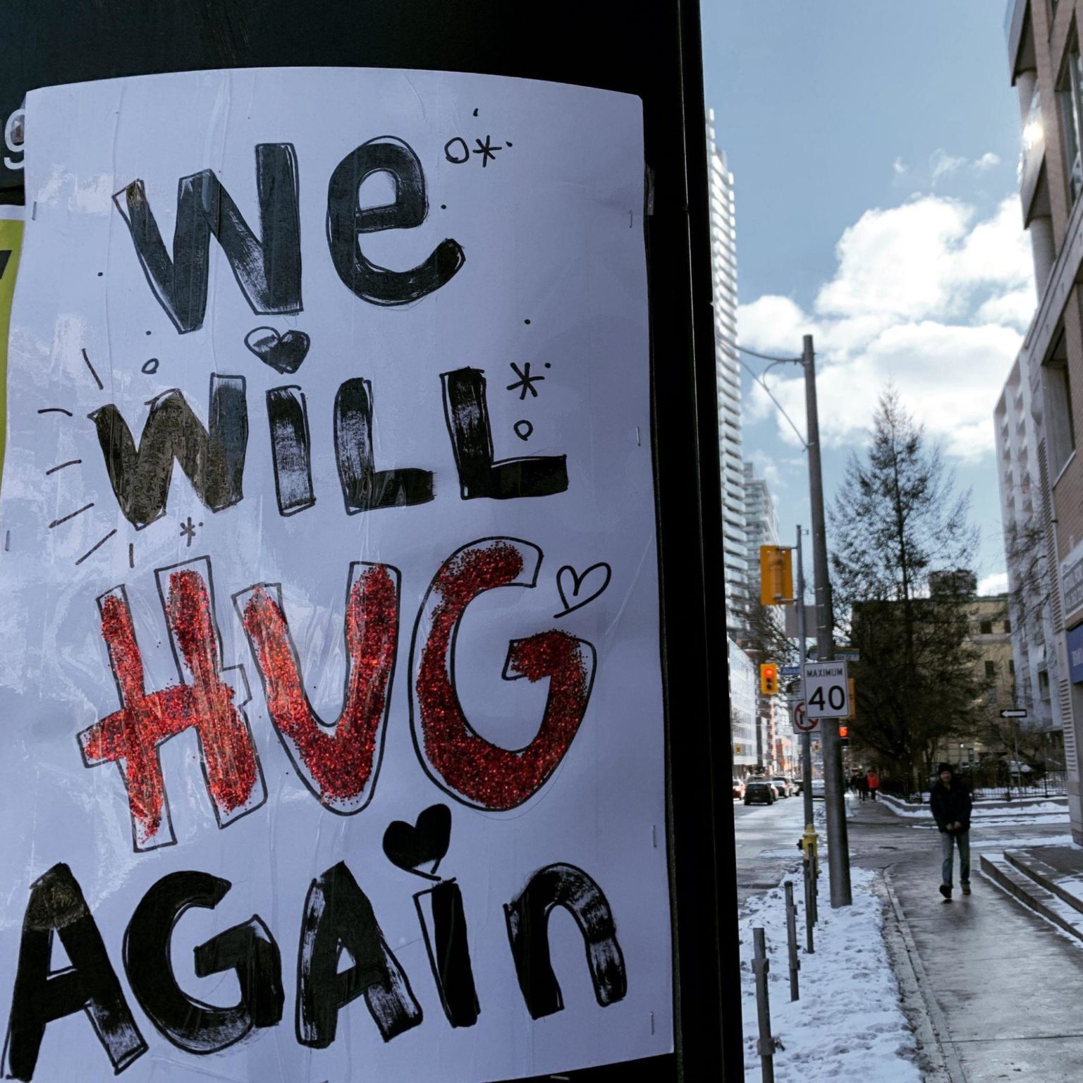 picture of a poster that reads 'we will hug again'