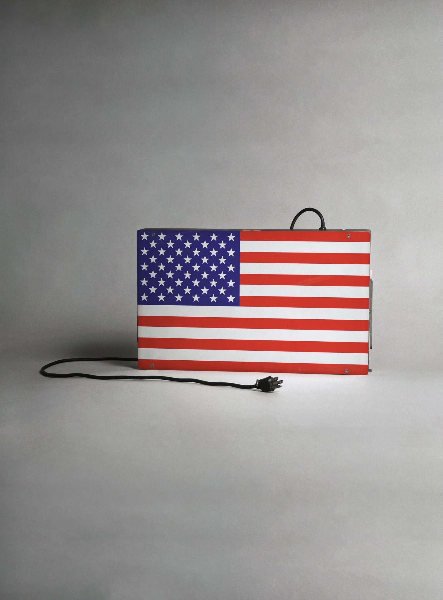 Image of a lamp in the shape and colours of the American flag, unplugged