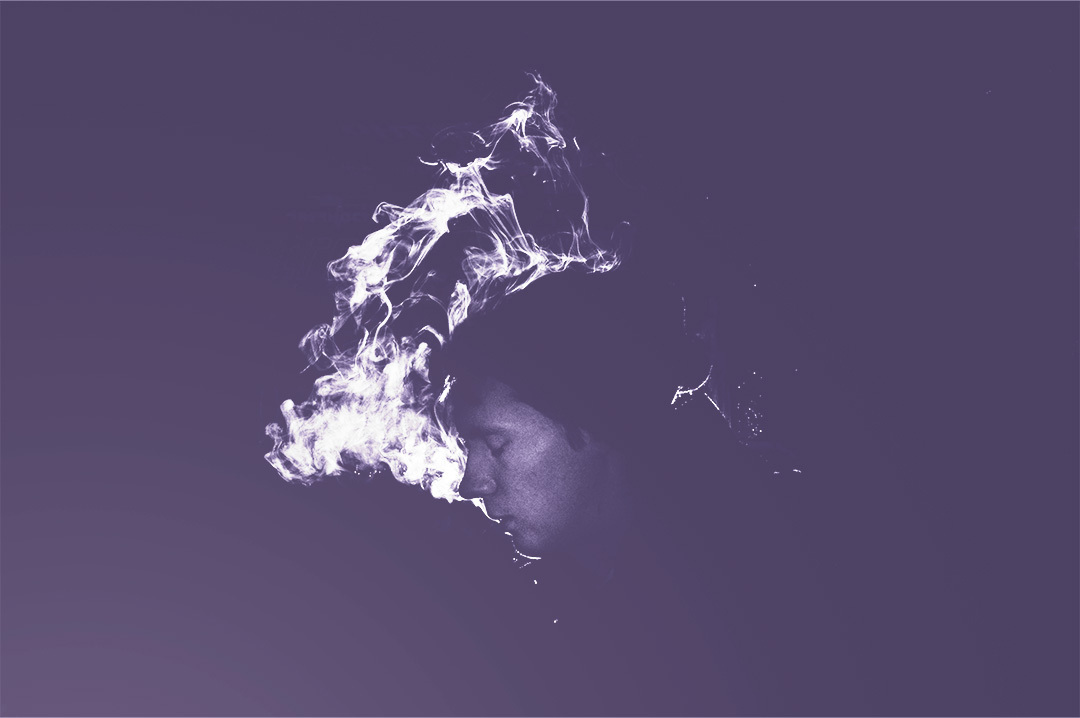 man surrounded by a cloud of smoke or air