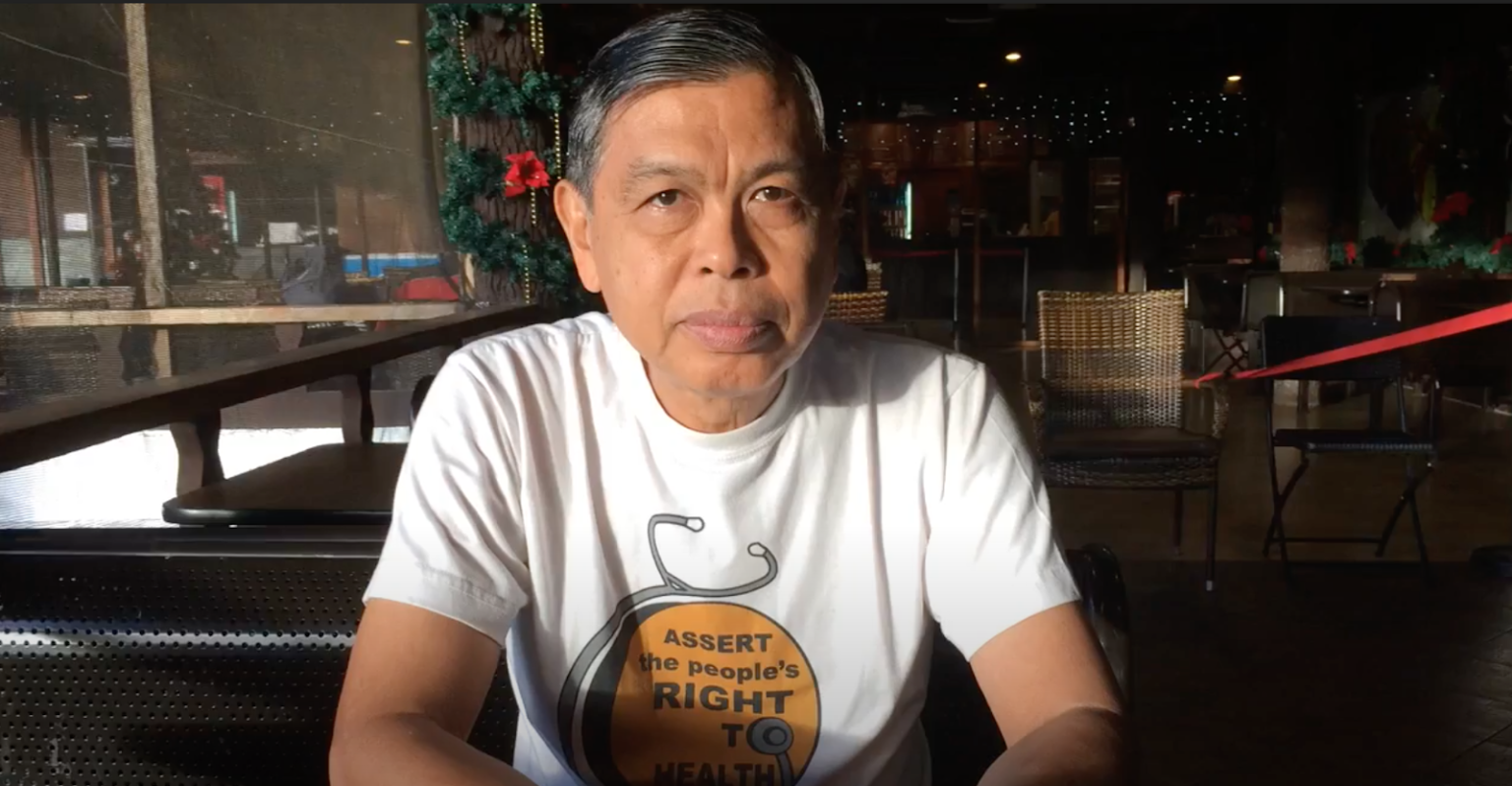 photo of a man, Dr. Romeo Quijano, his shirt reads 'assert the people’s right to health'.