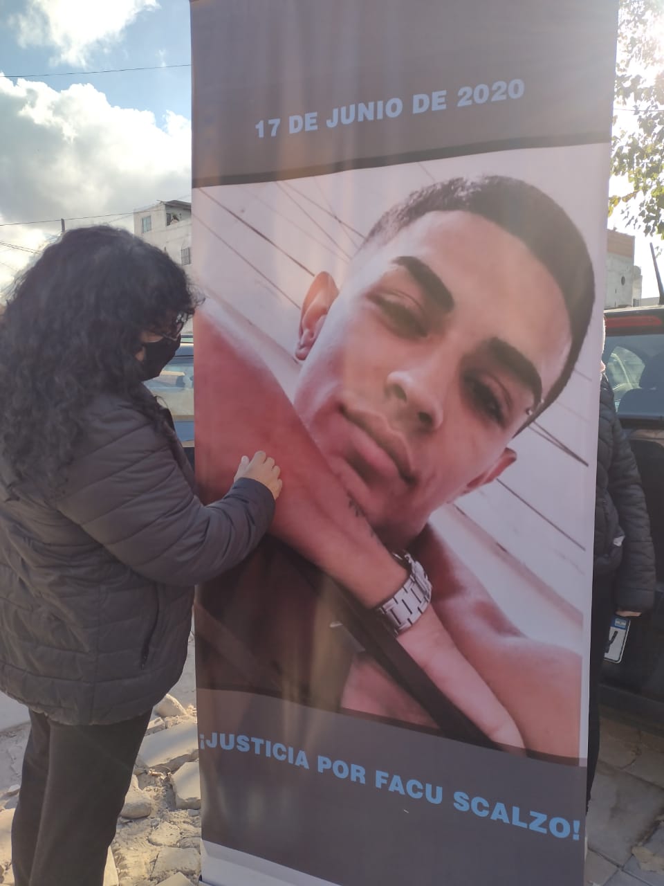 image of a poster of Facundo Scalzo, a woman is standing in front of the poster